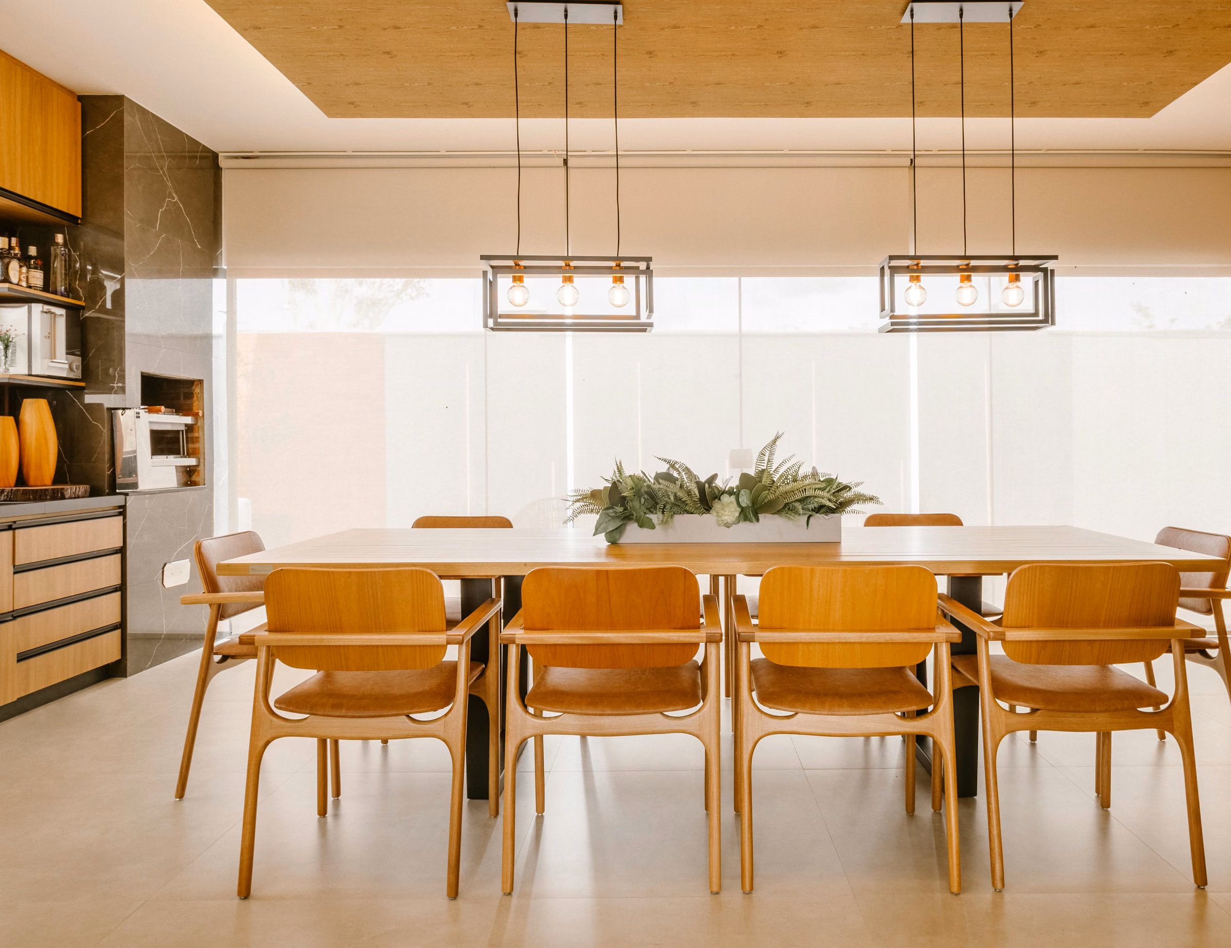 Sala de jantar integrada à cozinha, com forro de madeira e cadeiras de madeira maciça